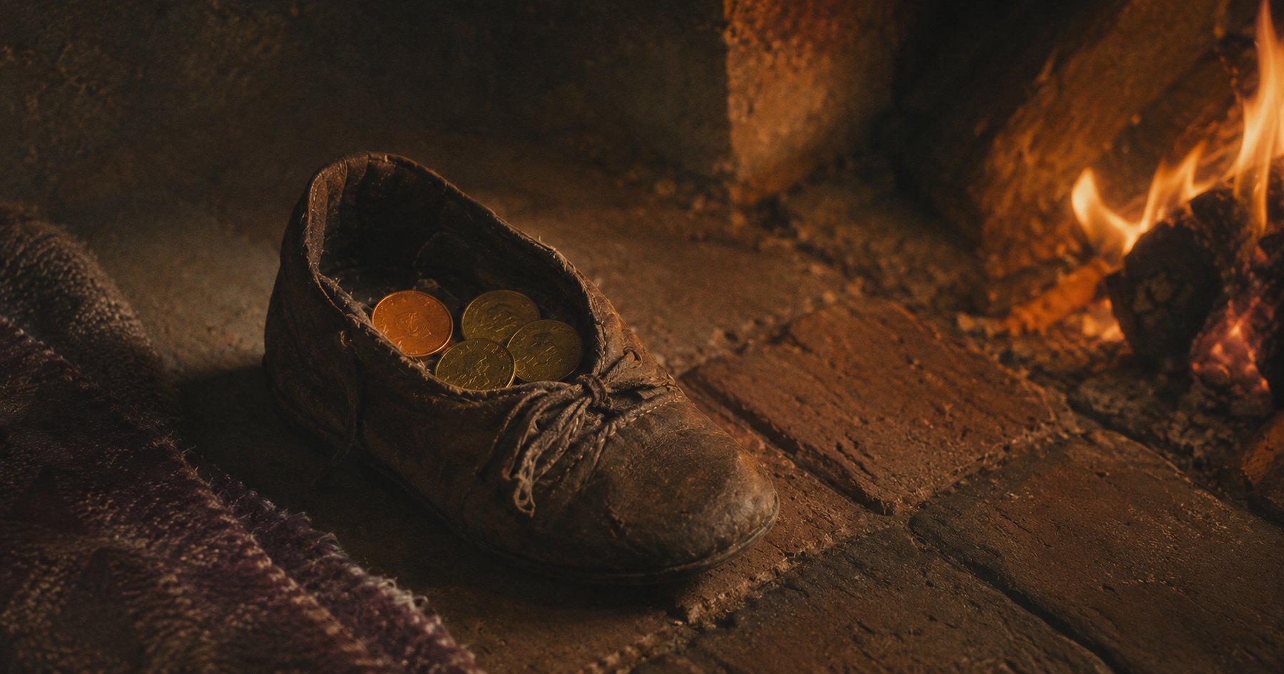 A child's worn leather shoe filled with gold coins on the hearthstones beside a low fire